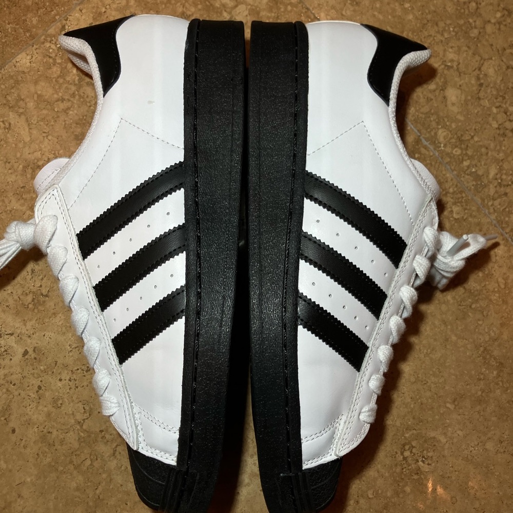 Black and white adidas superstar adv
